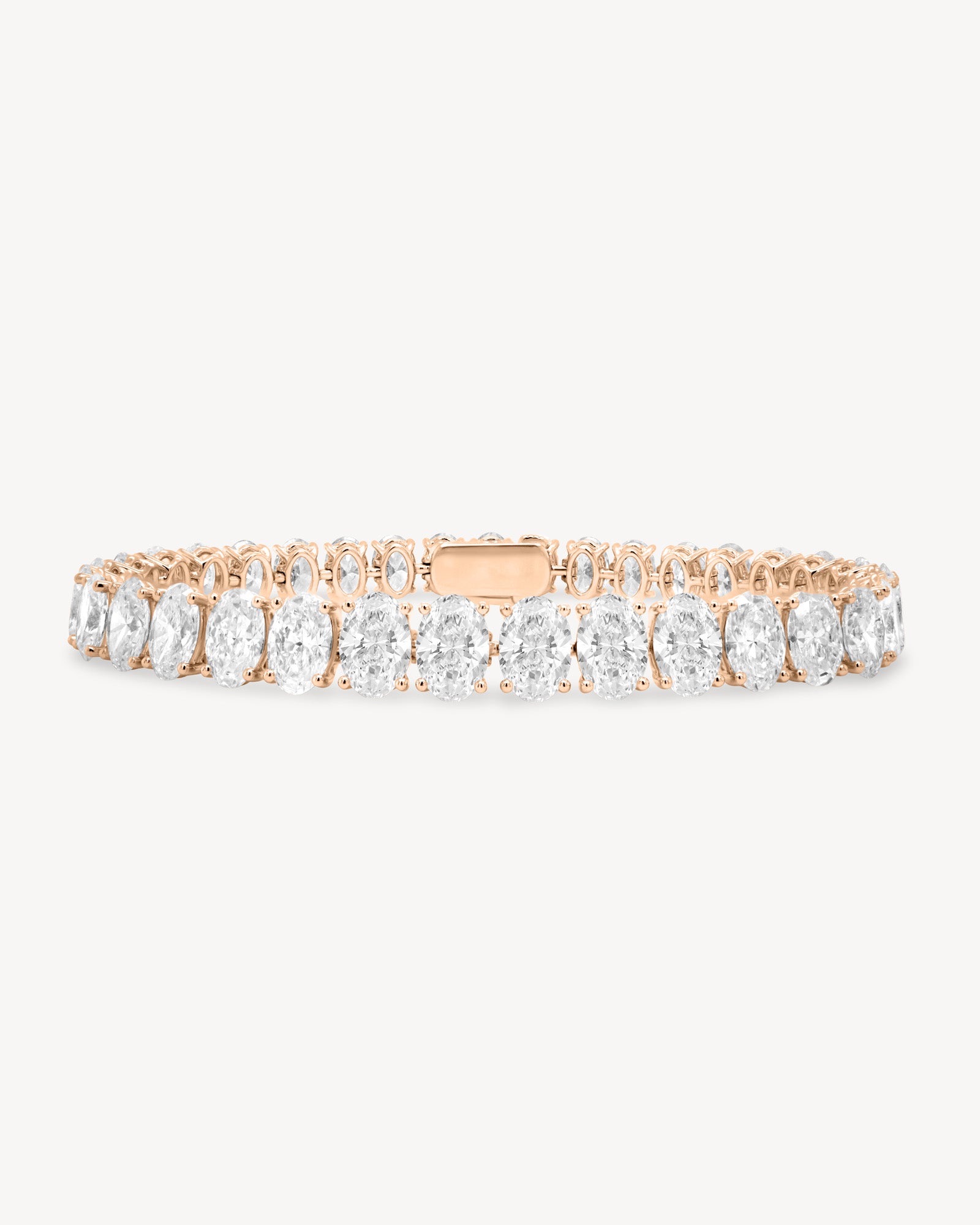 Oval cut diamond tennis bracelet in four-prong setting in rose gold