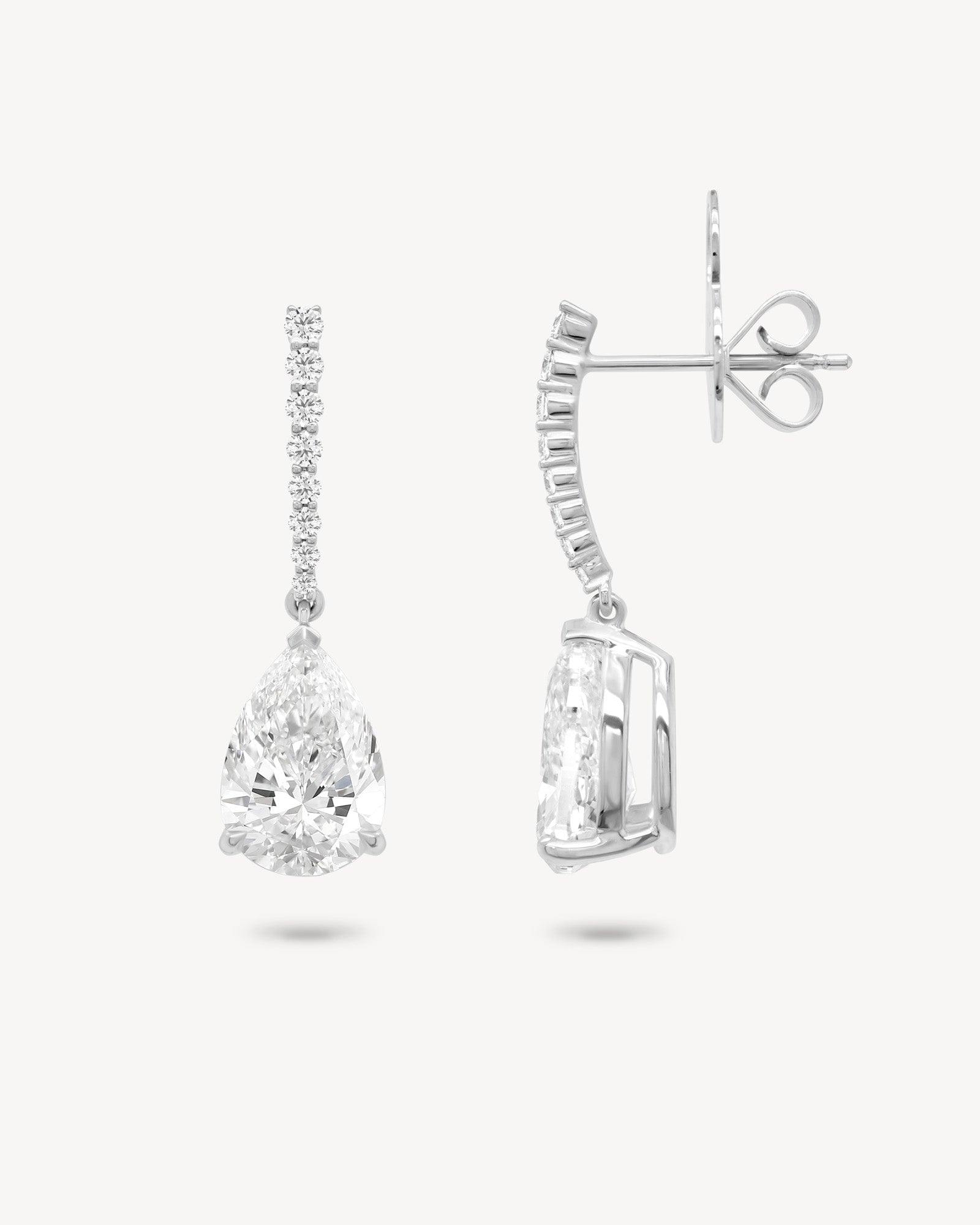 Pear cut diamond drop earrings in white gold, front and side view