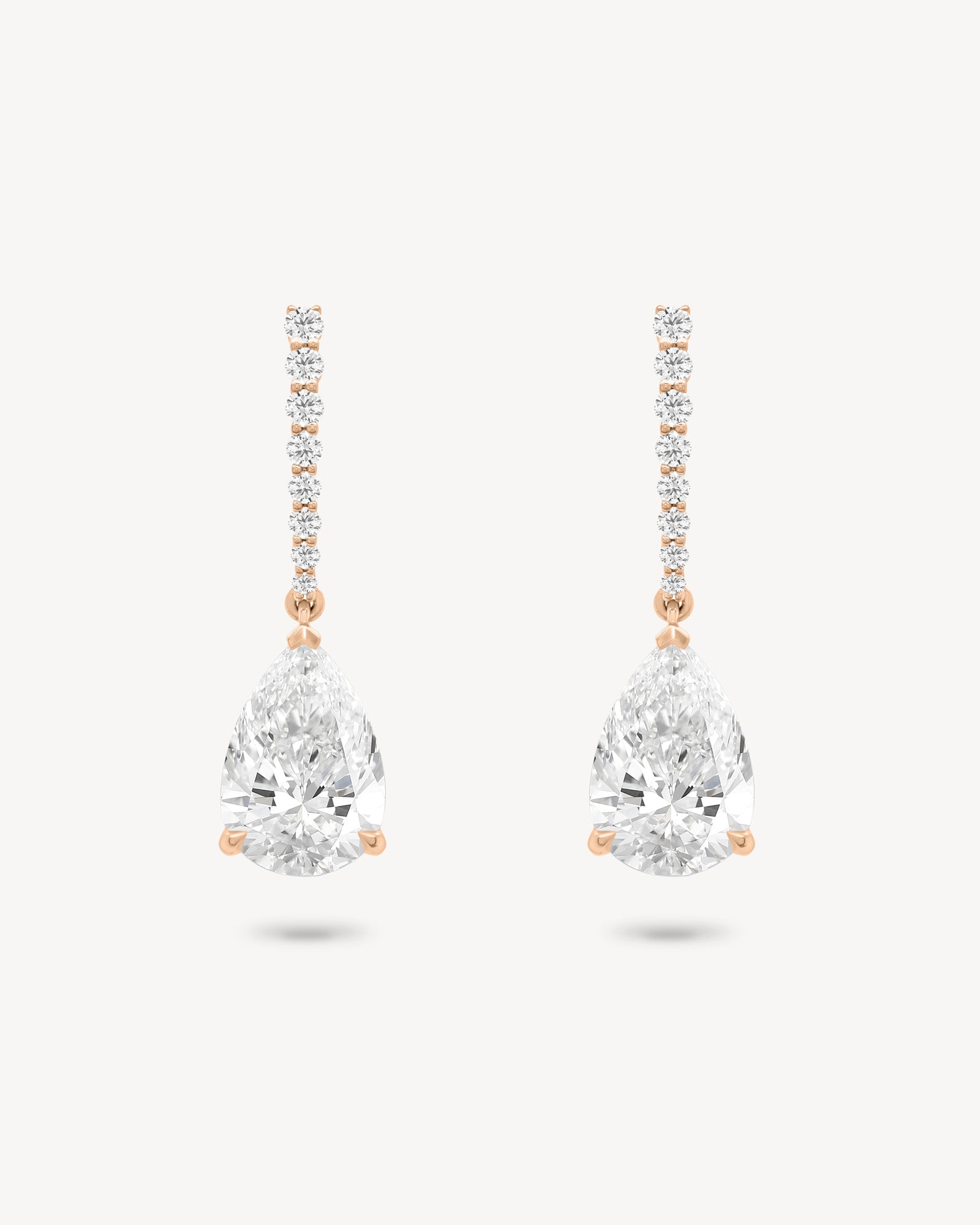 Pear cut diamond drop earring in rose gold