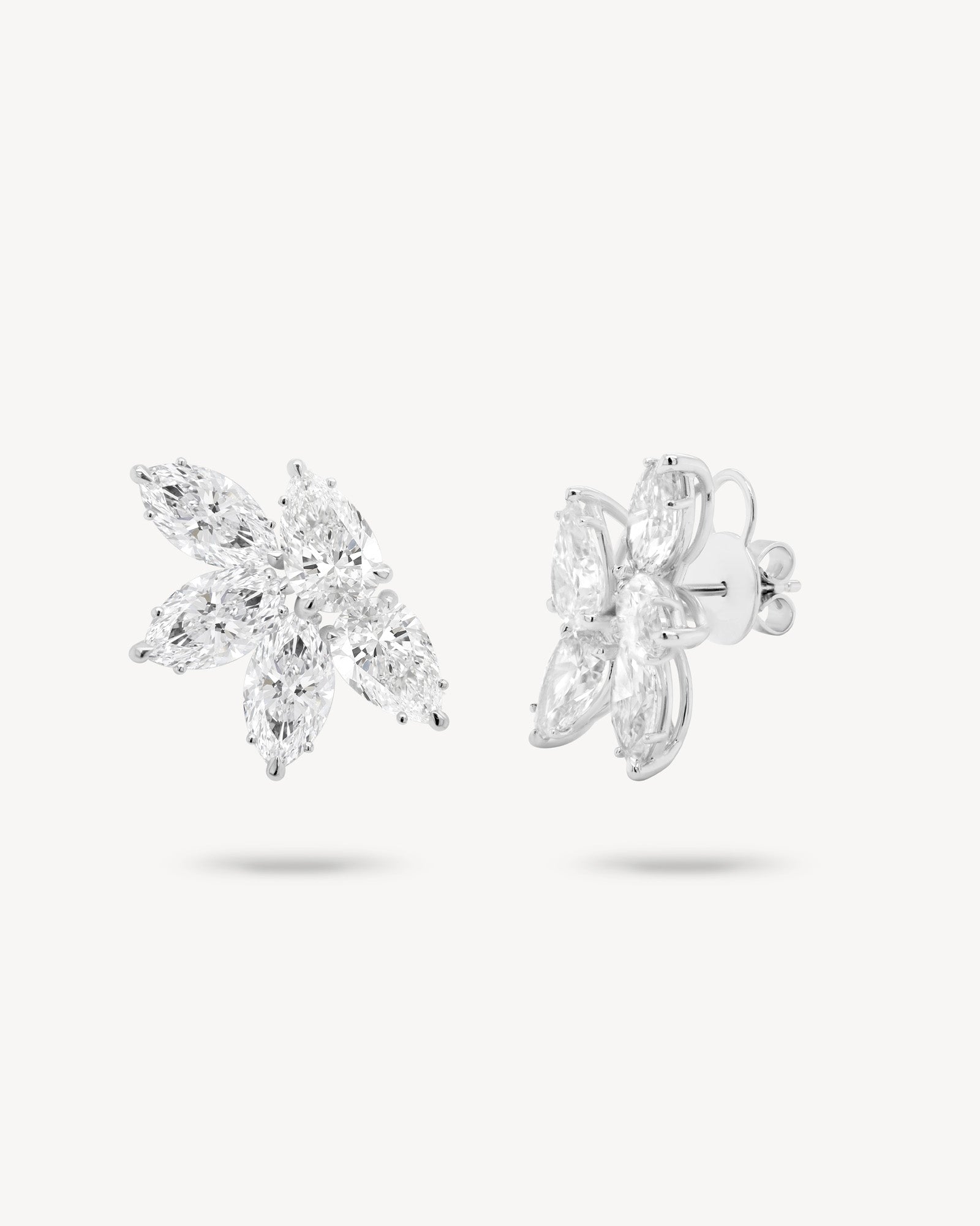 Marquise and pear cut diamond cluster stud earrings in white gold, front and side view