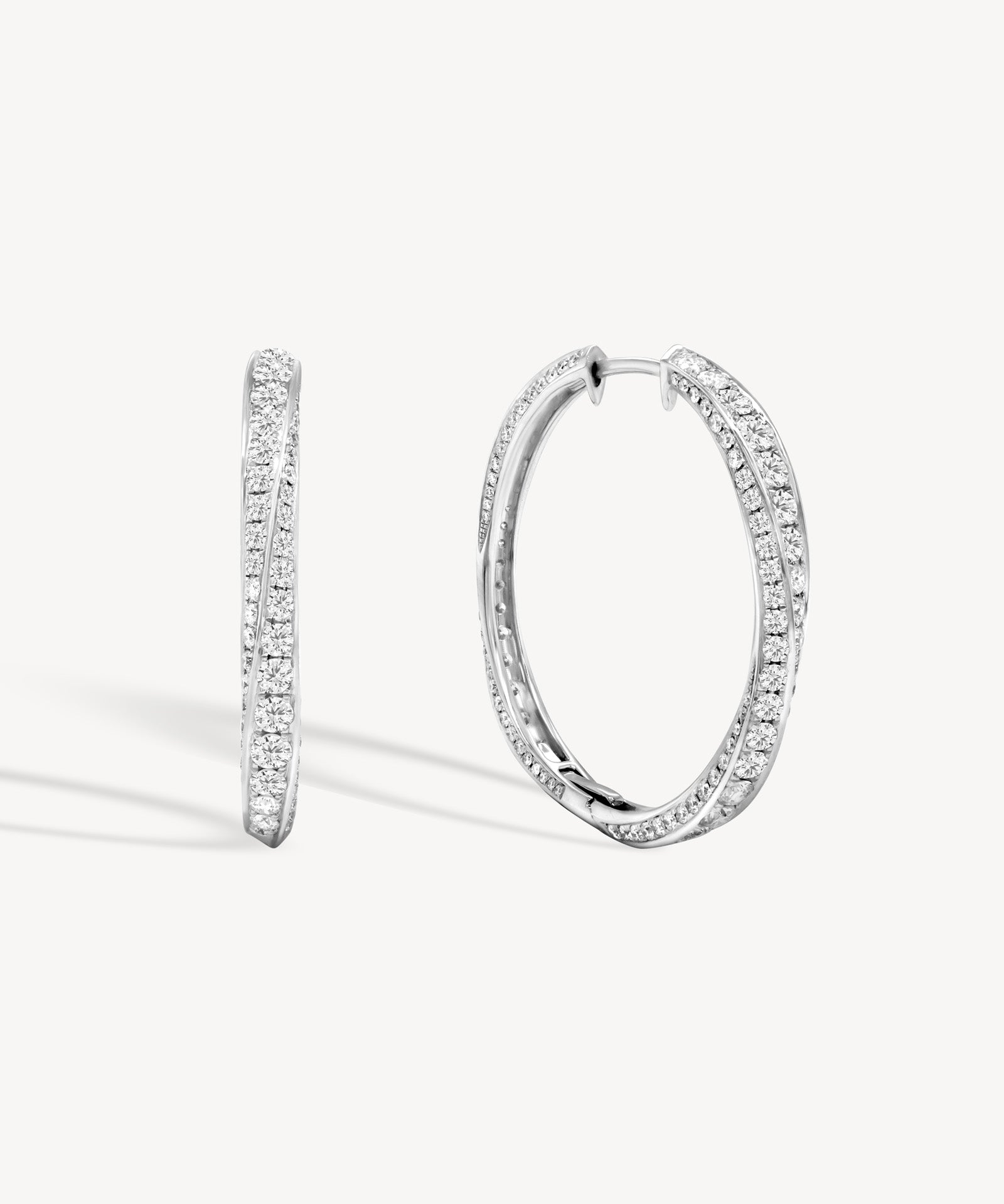 Spiral round cut diamond hoop earring in white gold