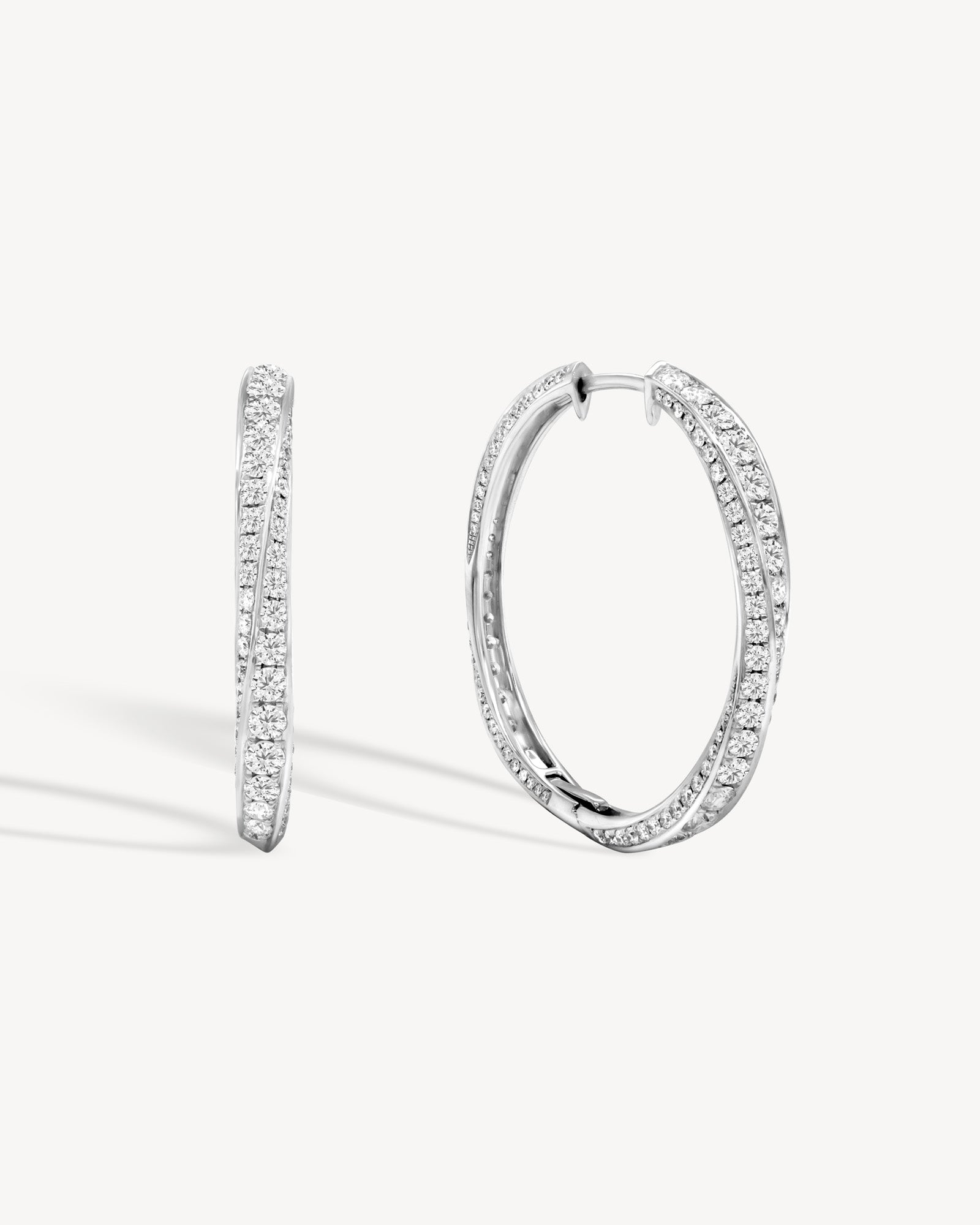 Spiral round cut diamond hoop earring in white gold