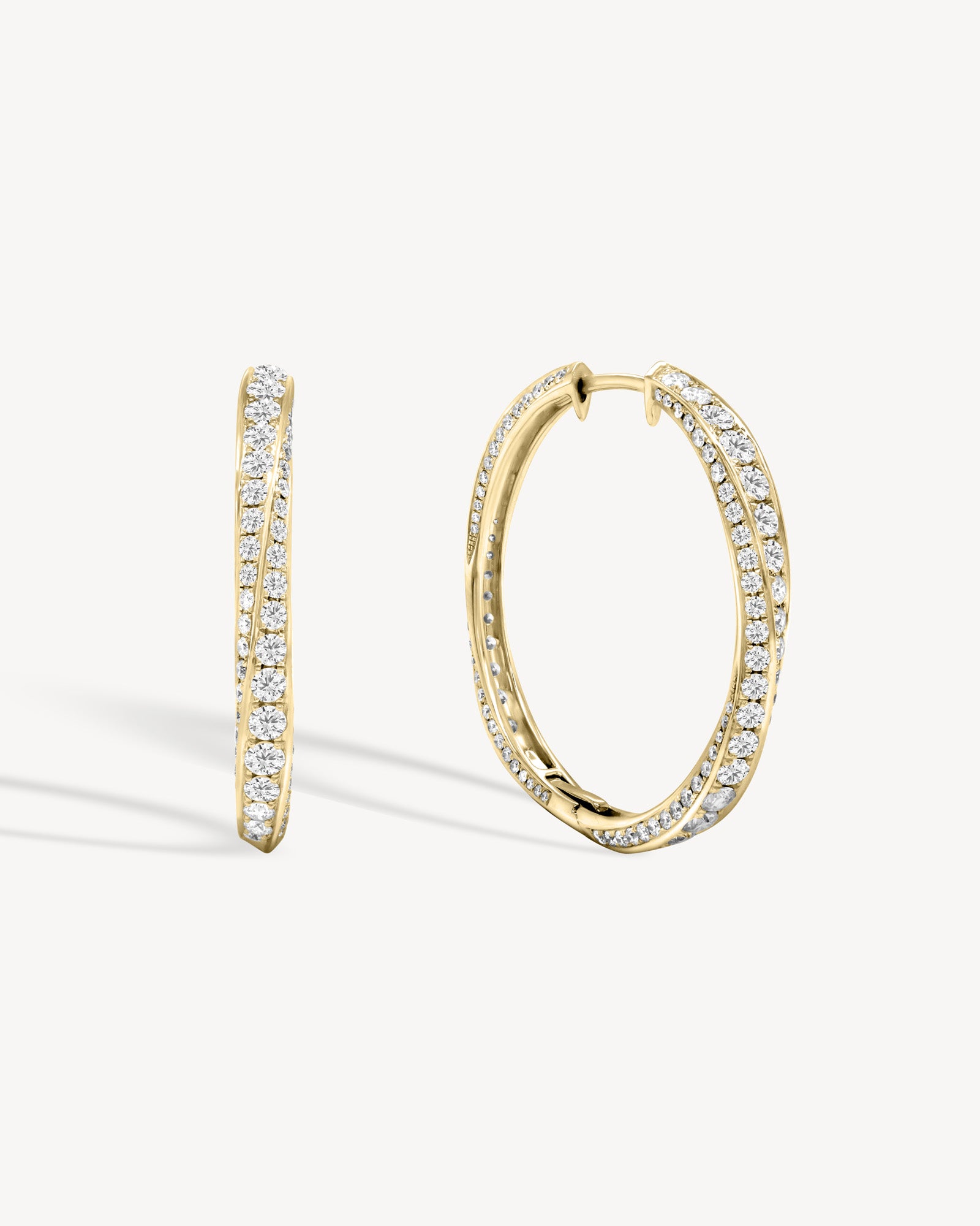Spiral round cut diamond hoop earring in yellow gold