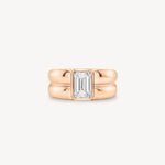 Emerald Cut diamond double gold band ring in 18K rose gold set against a white background