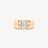Emerald Cut diamond double gold band ring in 18K rose gold set against a white background