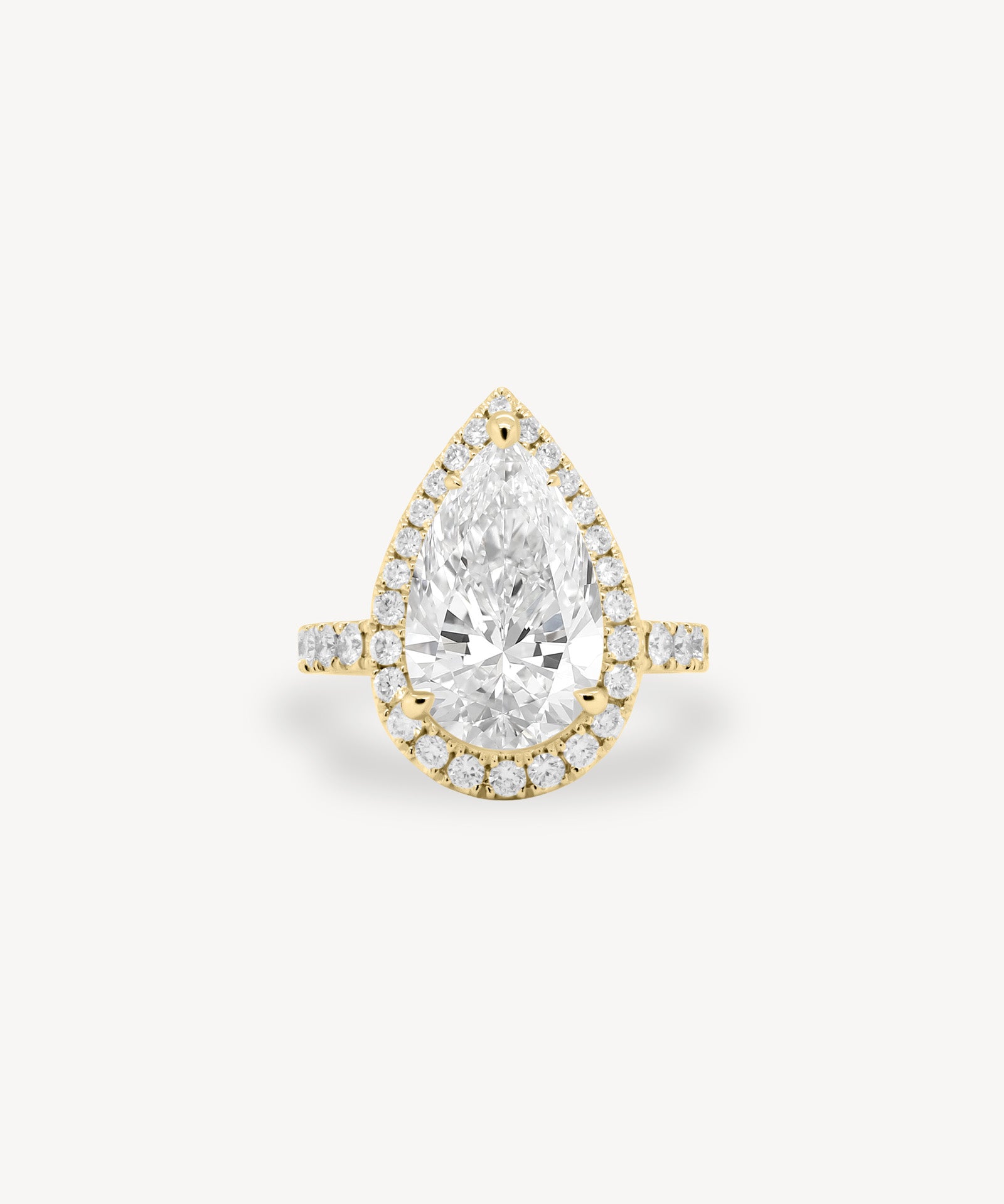 Pear Cut Diamond Halo Pavé Ring in Cathedral Setting