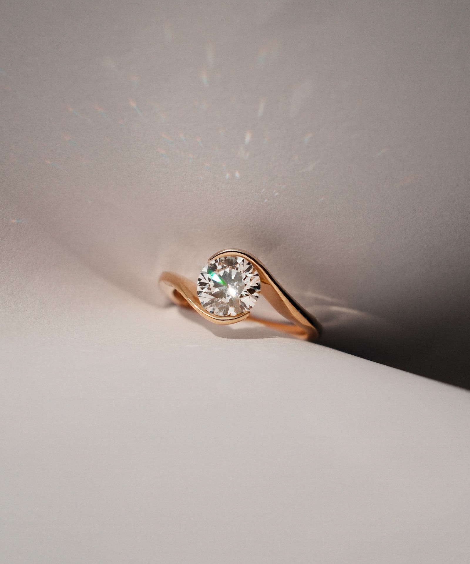 Round cut diamond bypass solitaire ring in yellow gold worn on hand – tinxx jewelry