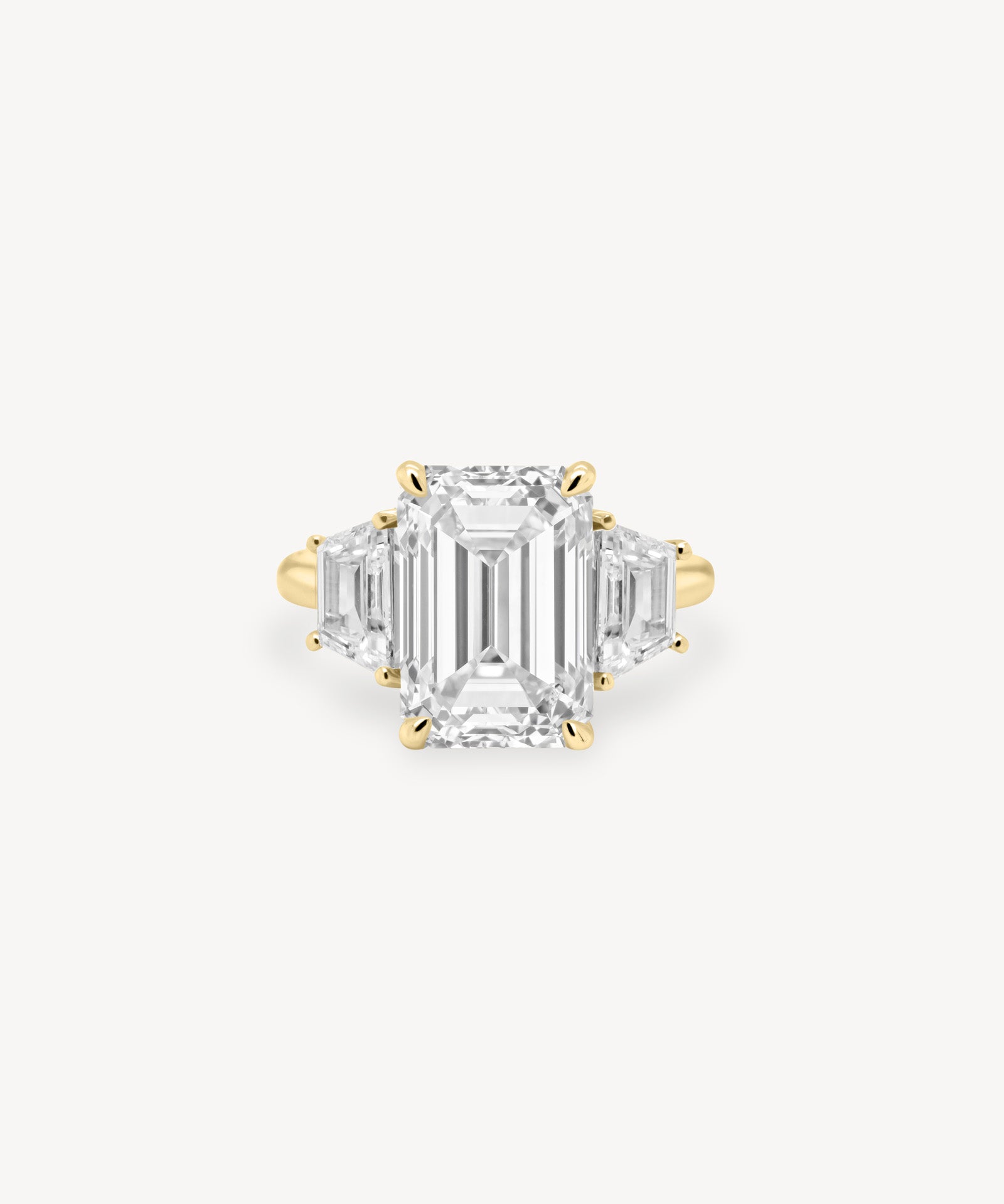 Emerald Cut Diamond Three Stone Ring With Trapezoid Cut Side Stones