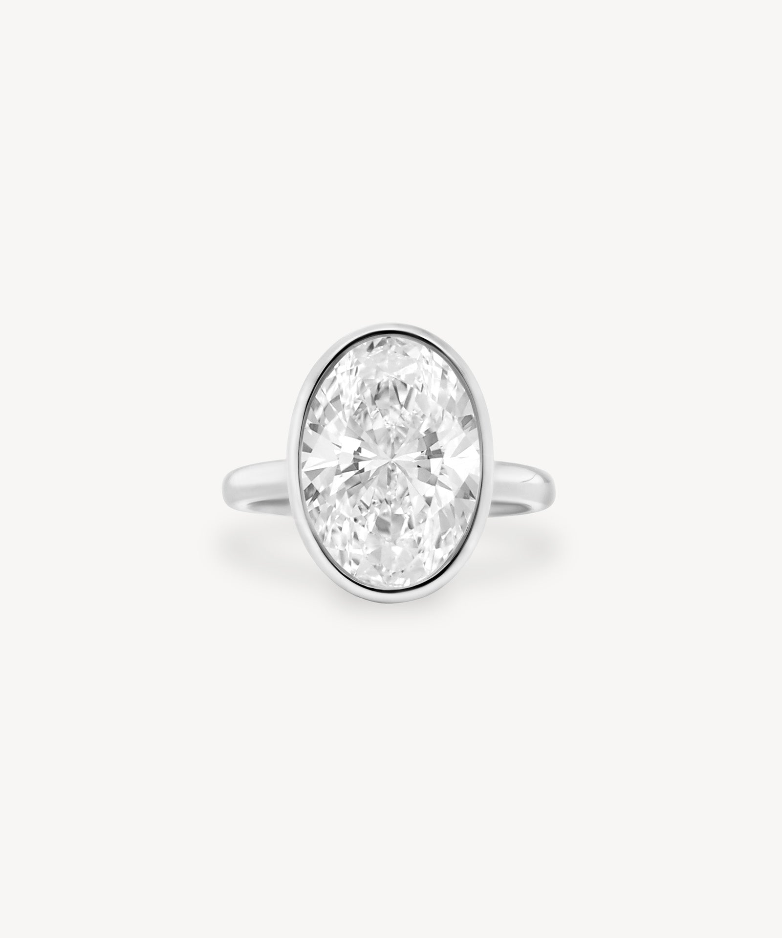 Oval Cut Diamond Solitaire Bezel Ring with Hidden Halo