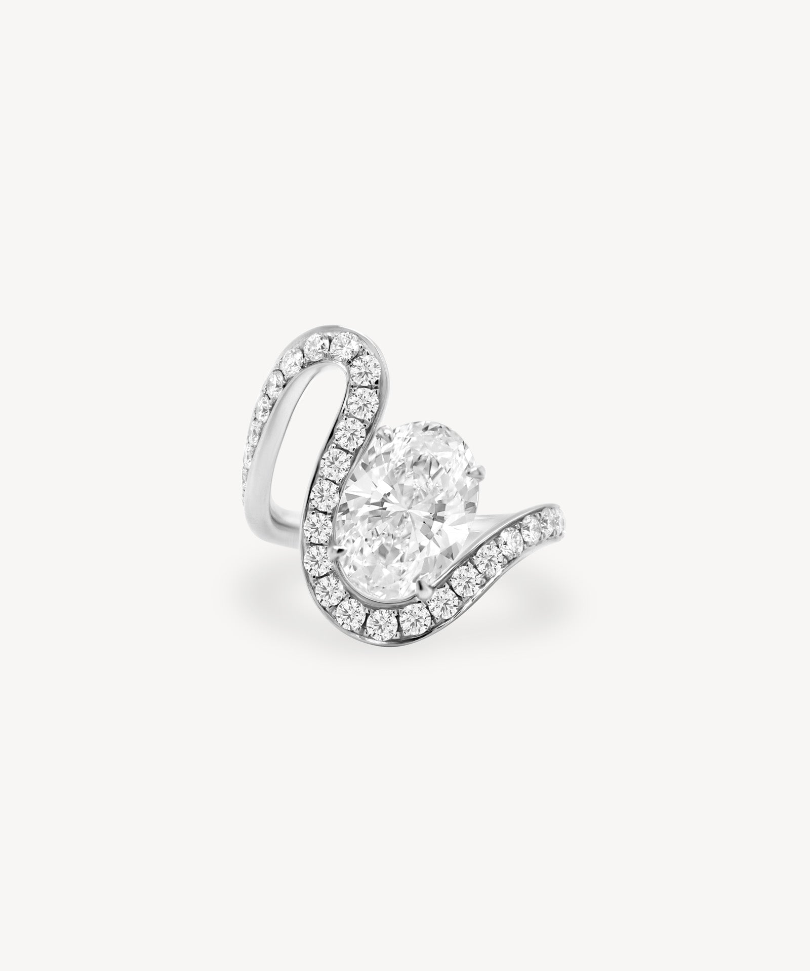 Oval cut diamond wave pavé ring in white gold