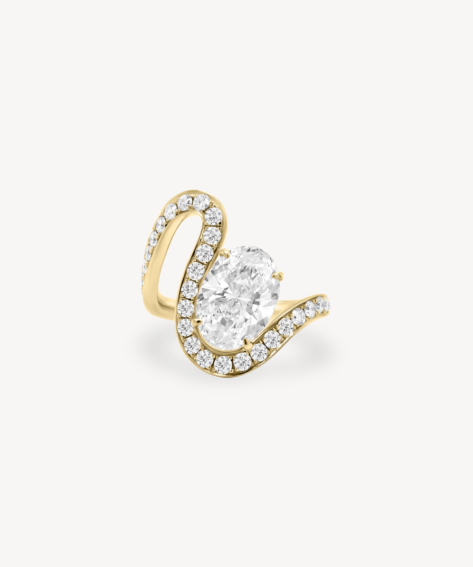 Oval cut diamond wave pavé ring in yellow gold