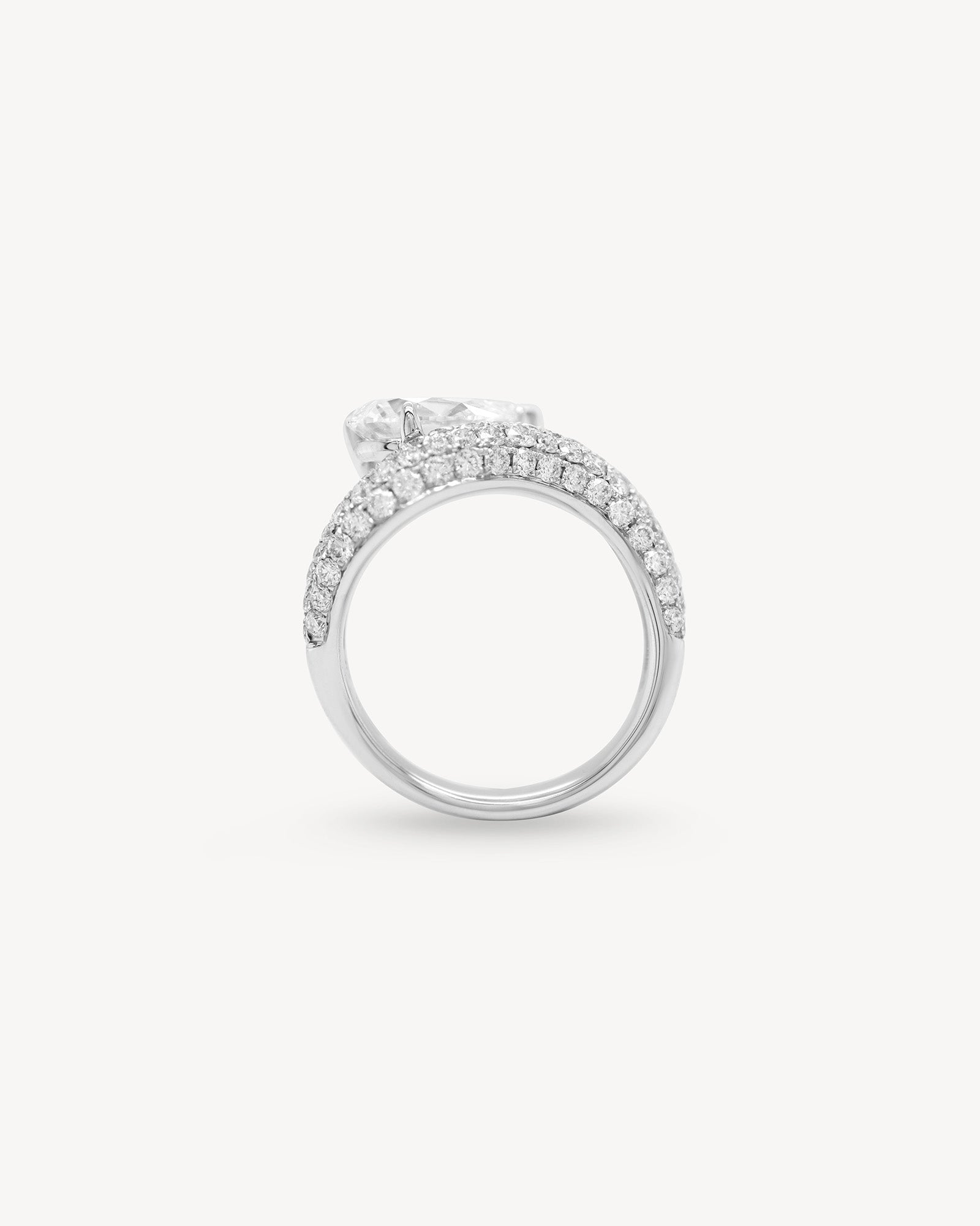 Pear cut diamond wave pavé dome ring in white gold, side view