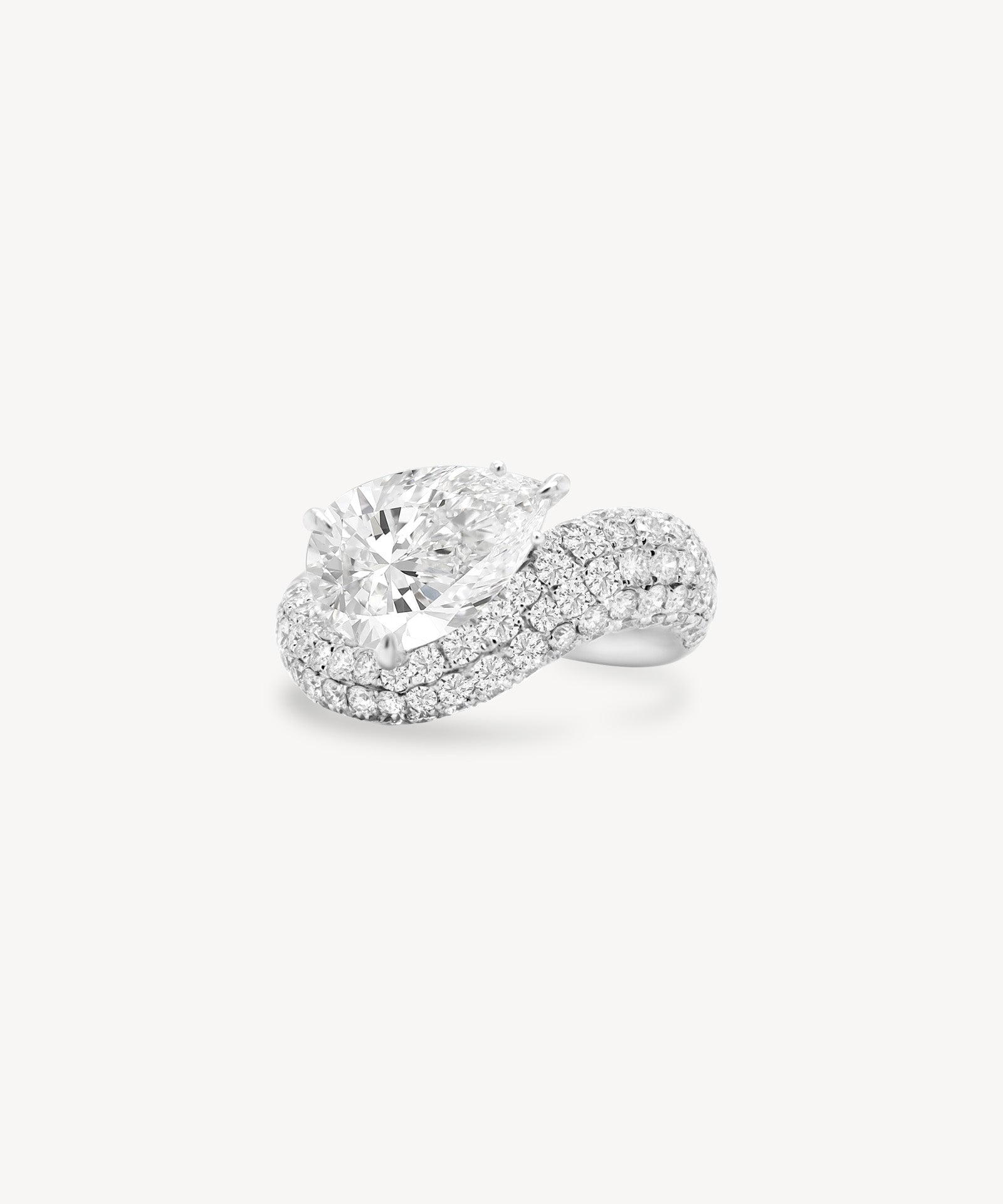 Pear cut diamond wave pavé dome ring in white gold