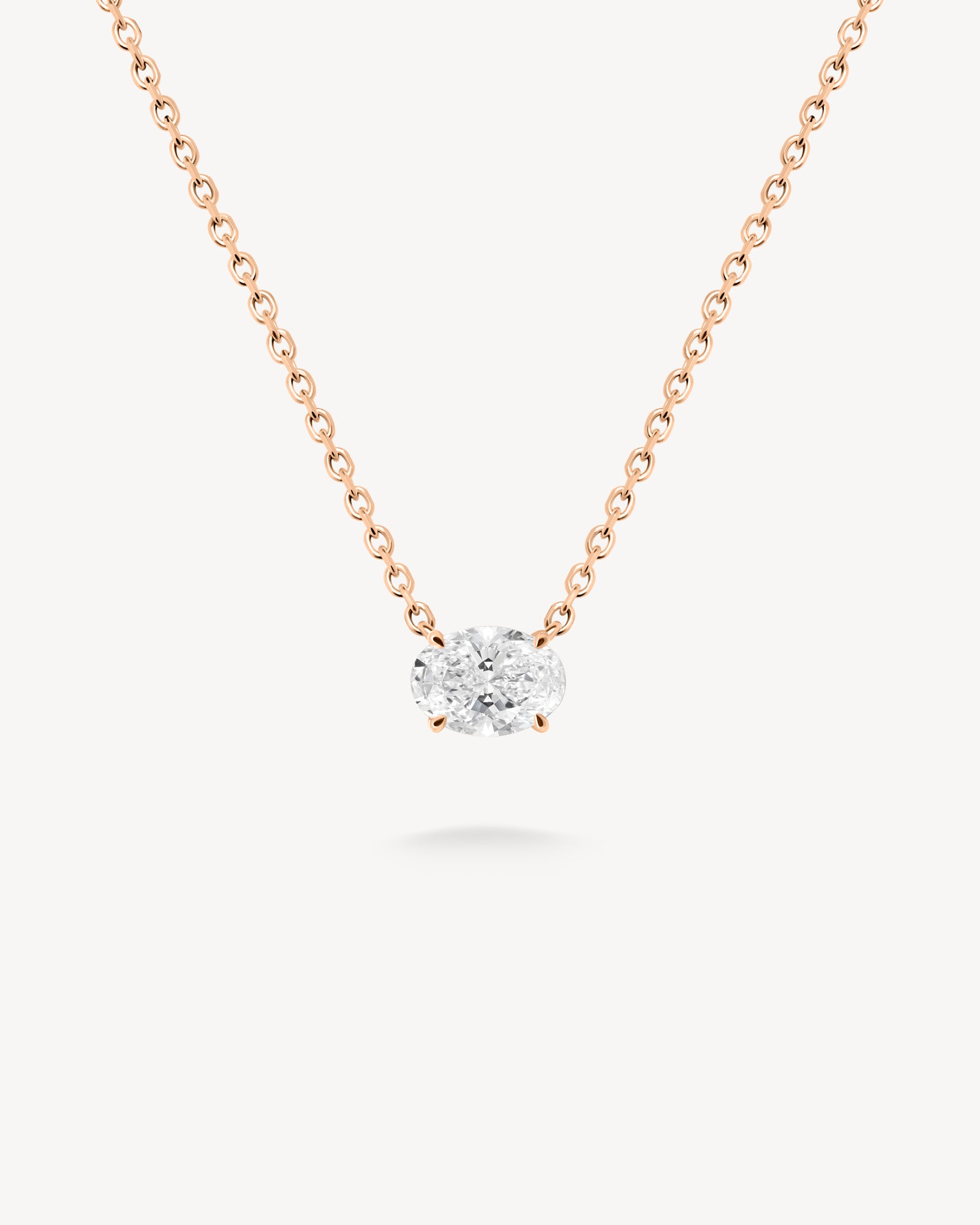 East-west oval cut diamond solitaire necklace in rose gold