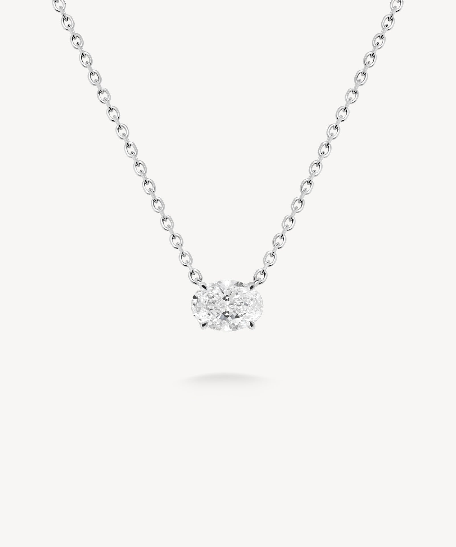 East-west oval cut diamond solitaire necklace in white gold