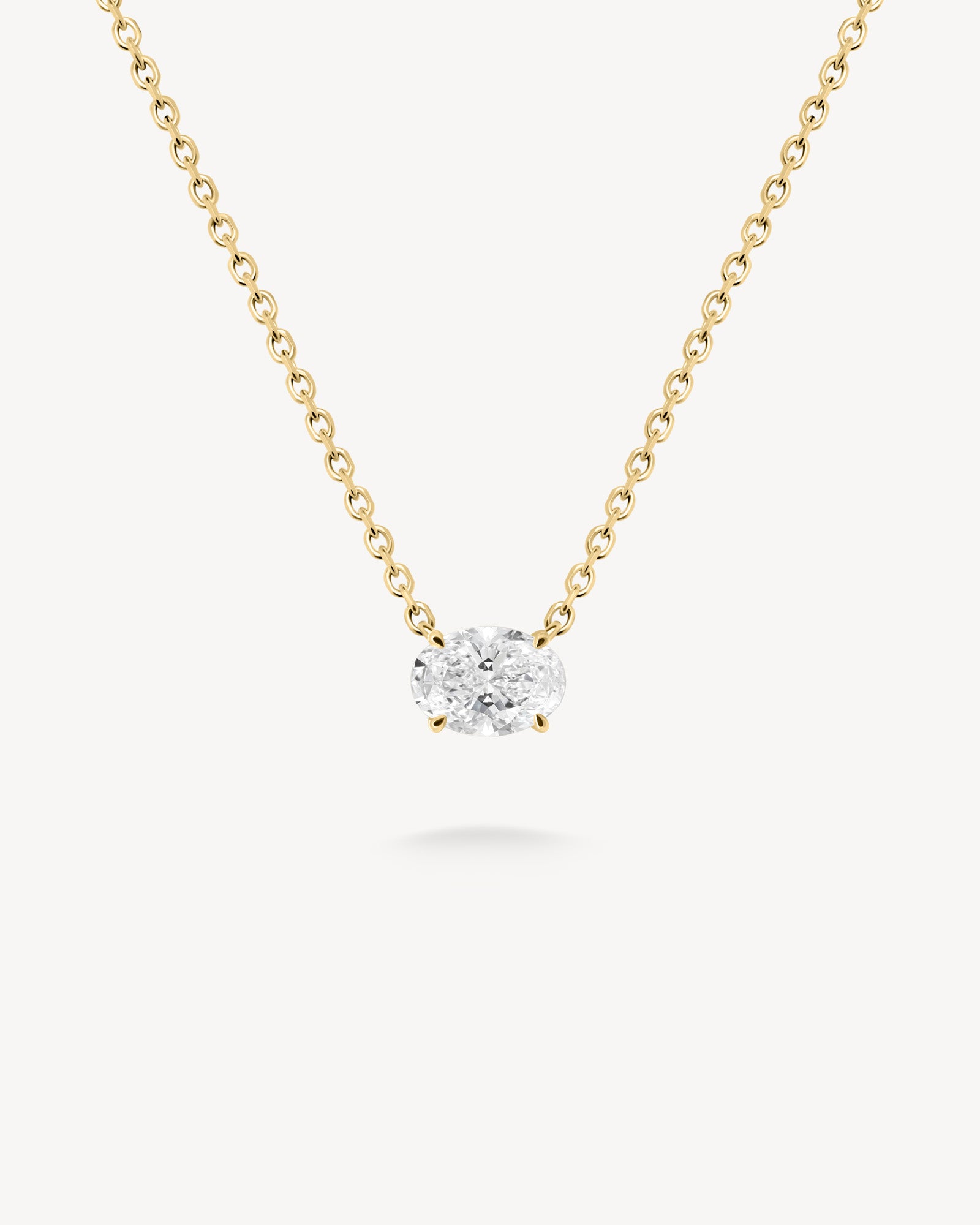 East-west oval cut diamond solitaire necklace in yellow gold