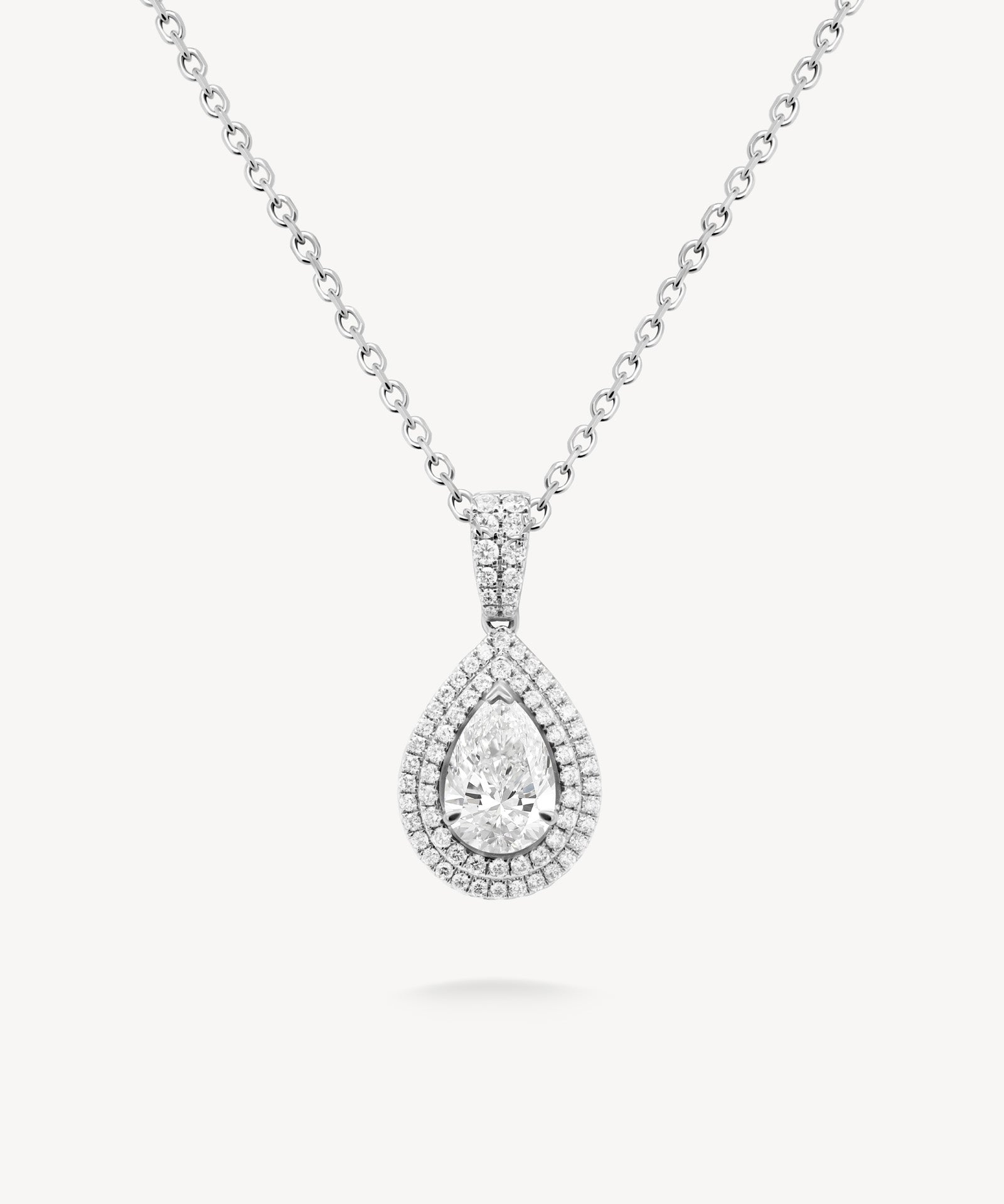 Pear cut diamond double halo pendant necklace in white gold