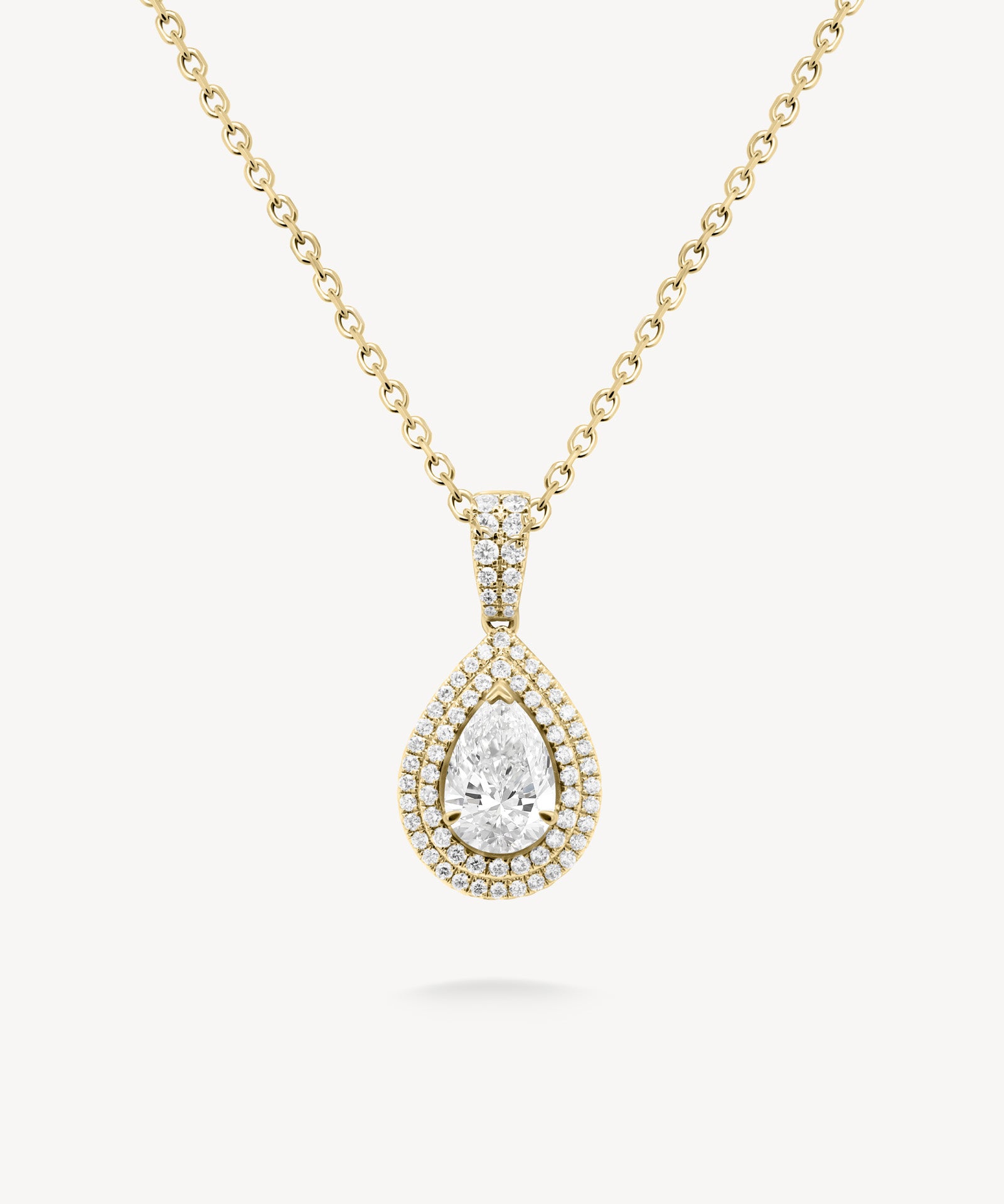Pear cut diamond double halo pendant necklace in yellow gold