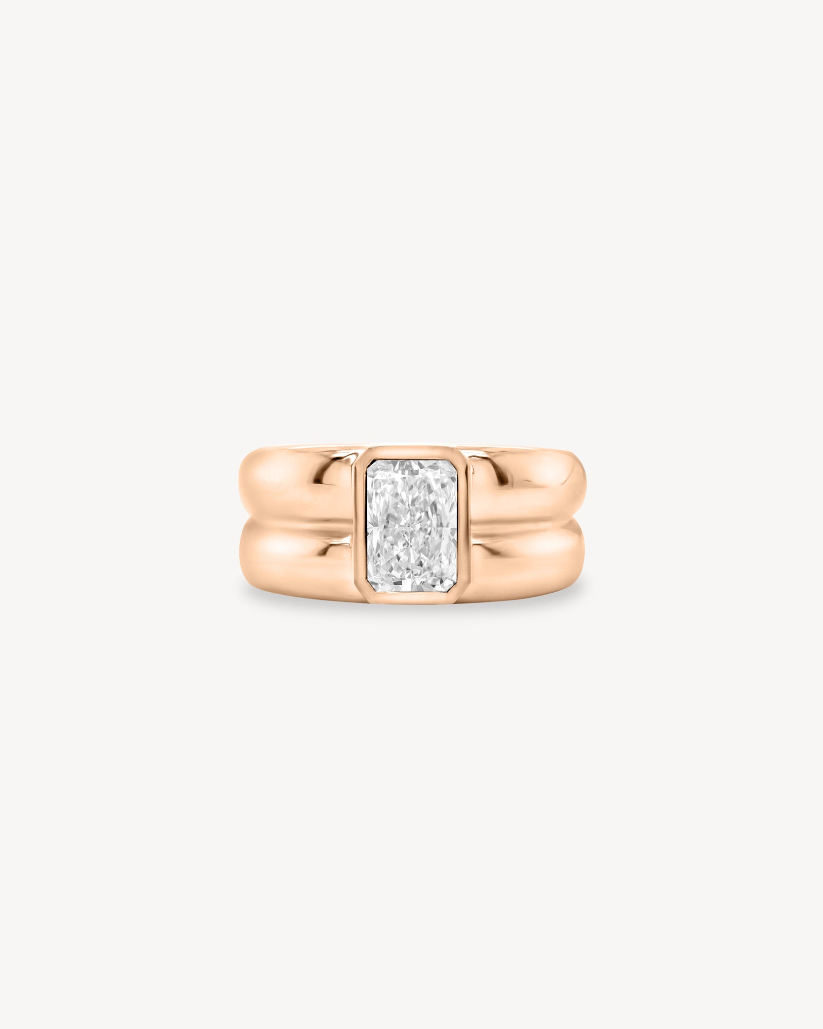 Radiant Cut diamond double gold band ring in 18K rose gold set against a white background