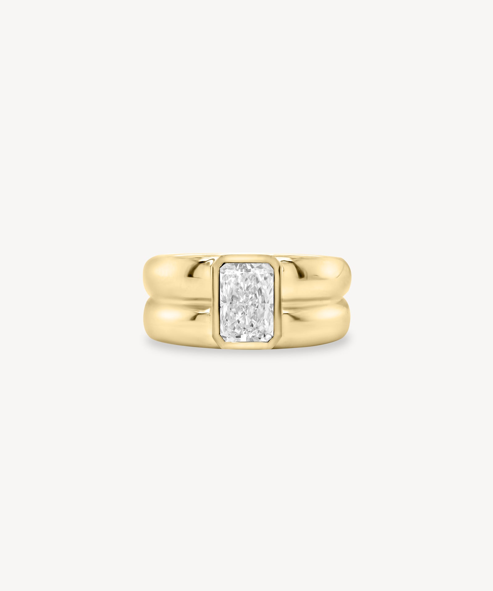 Radiant Cut diamond double gold band ring in 18K yellow gold set against a white background