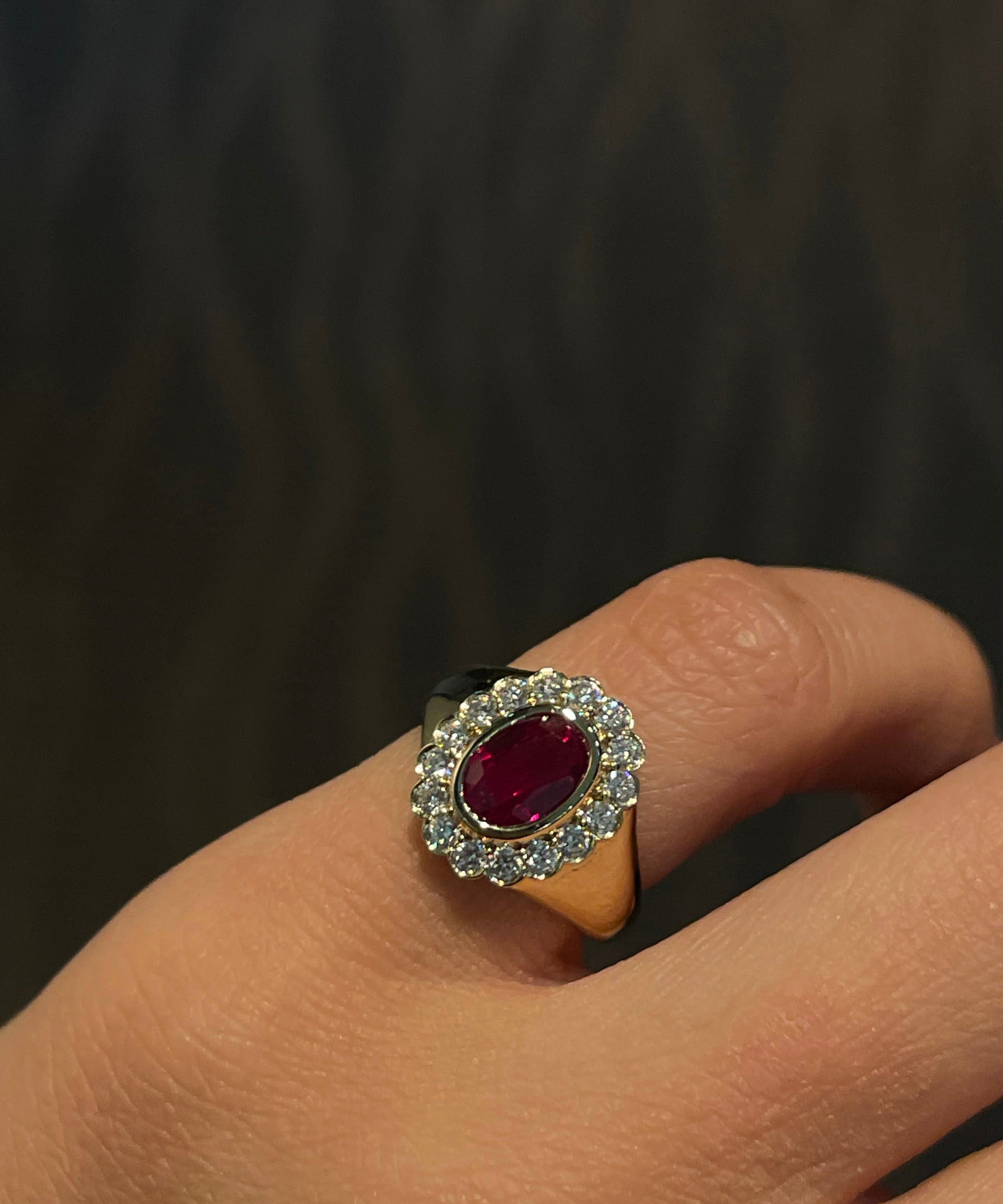 Diamond Signet Ring with a ruby on a pinky finger against a dark background