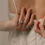 Close-up of bride's hands with baguette diamond rings