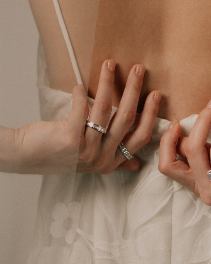 Close-up of bride's hands with baguette diamond rings