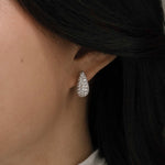 diamond teardrop earrings on ear with pavé setting in bridal styling