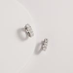 emerald diamond hoops against white background