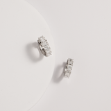 emerald diamond hoops against white background