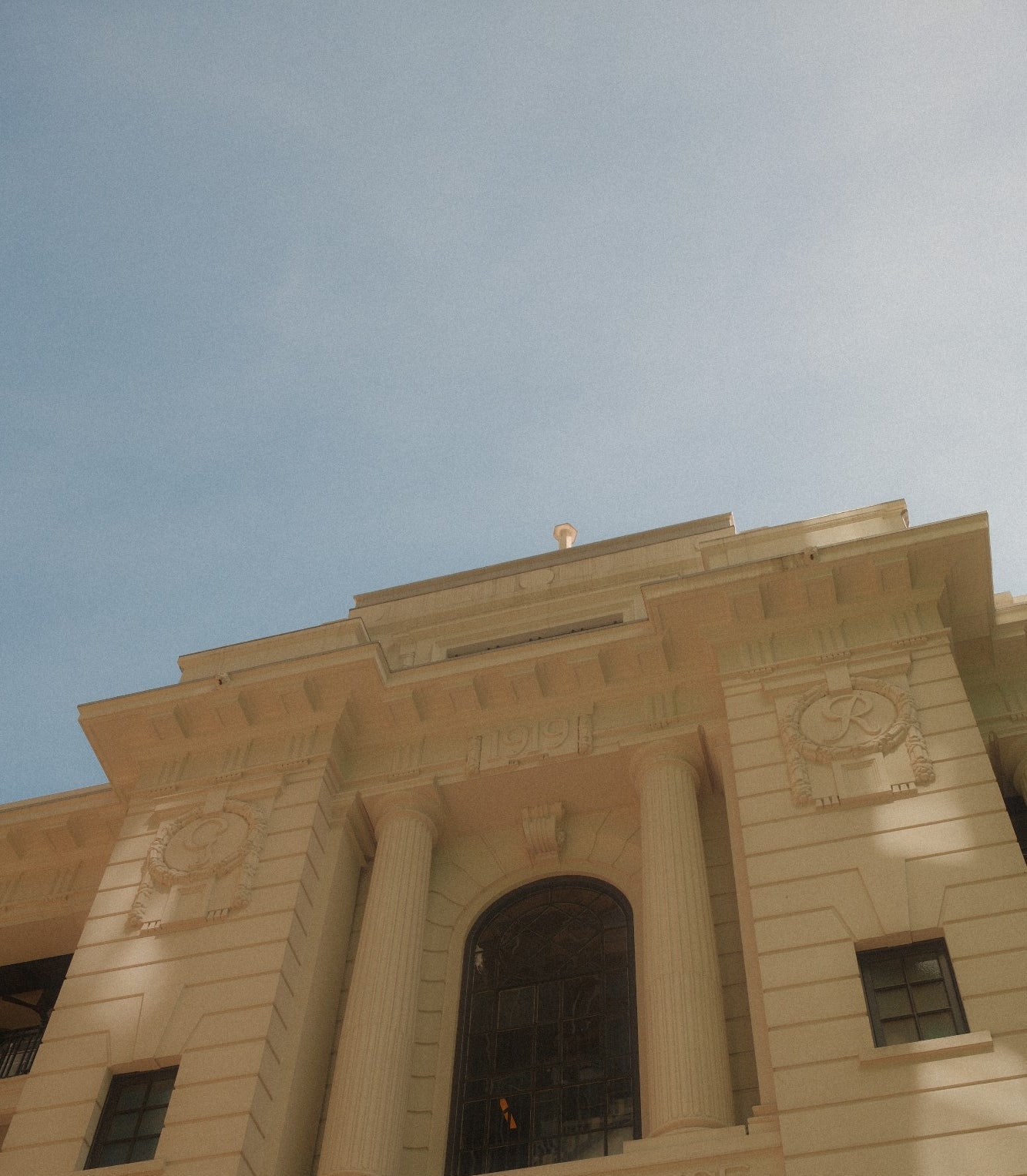 Former Central Police Station (1919 Police Building) in Hong Kong against a blue sky
