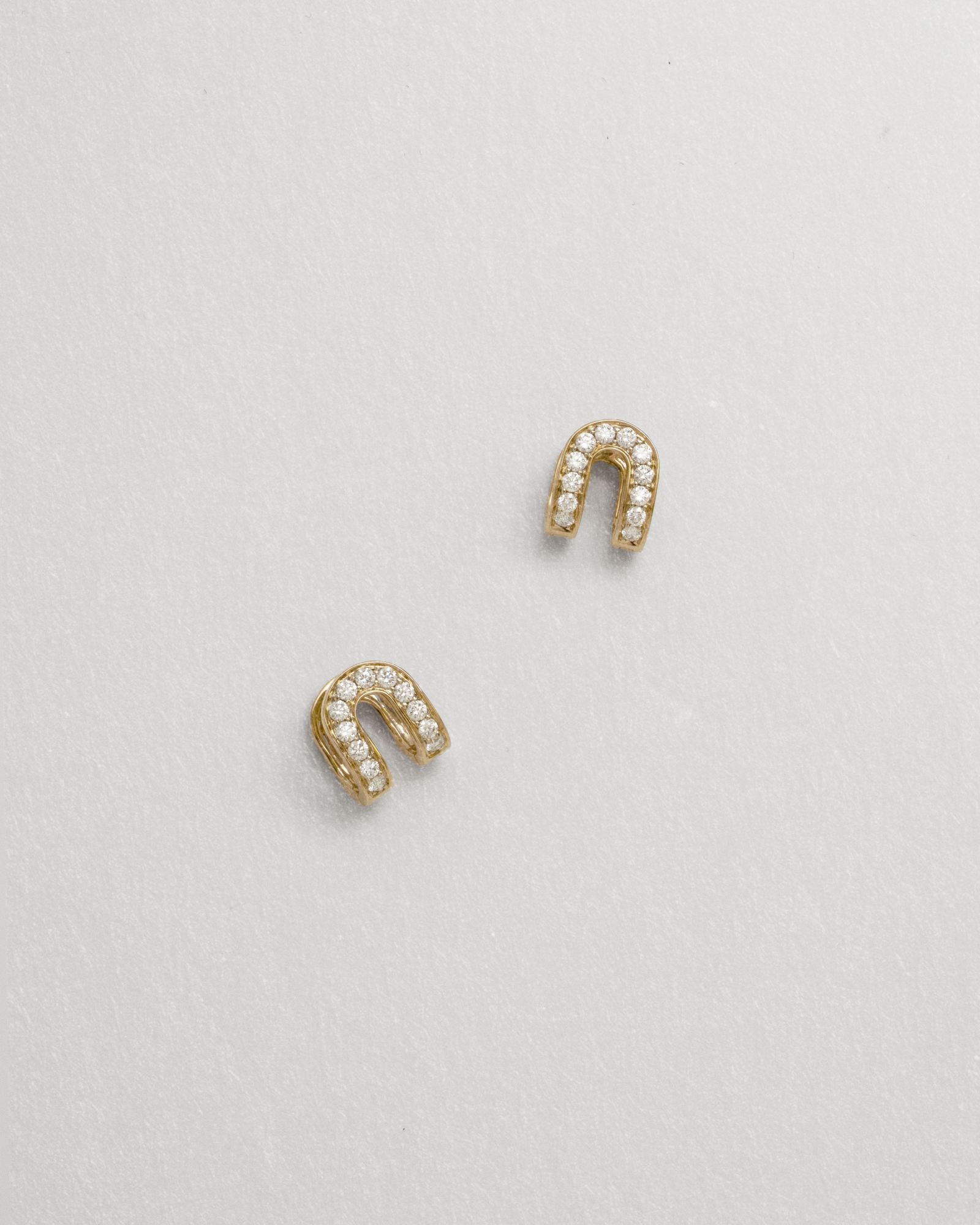 diamond huggies shaped as a horseshoe against a white background