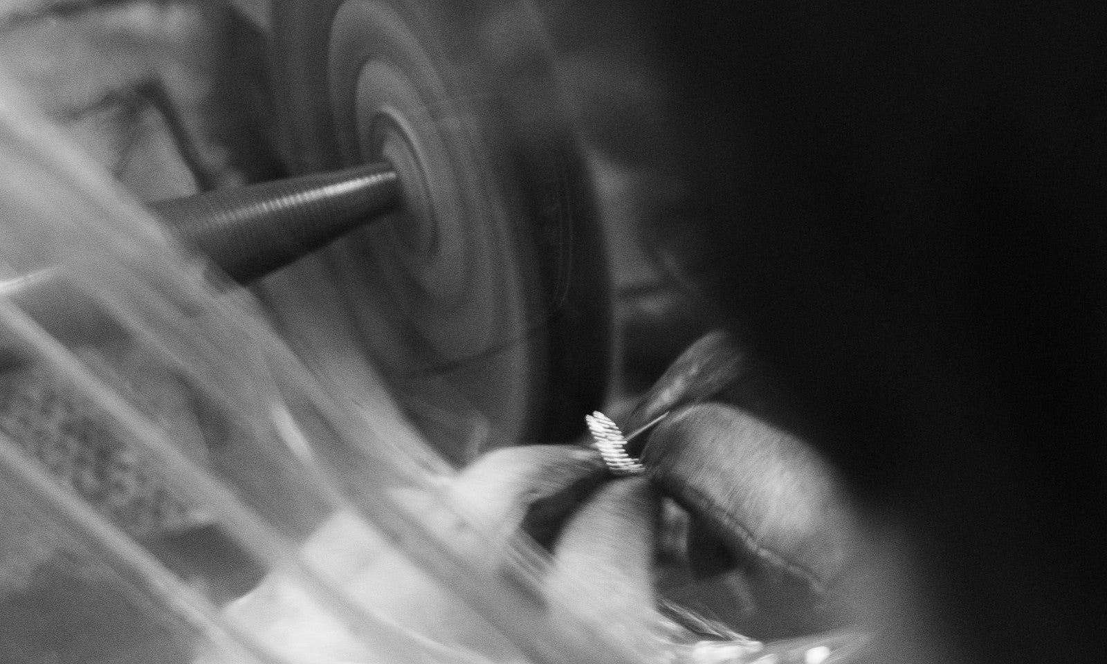 Close-up of a person polishing a piece of jewelry.