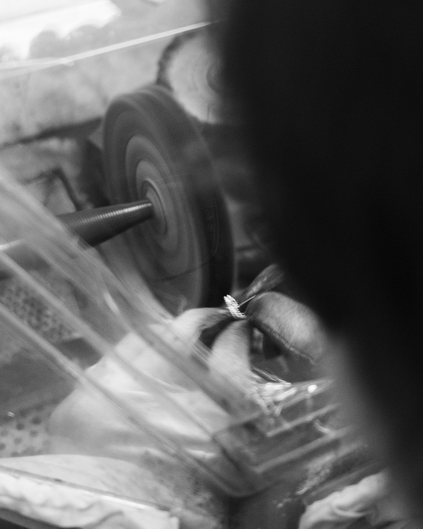 Close-up of a person polishing a piece of jewelry.