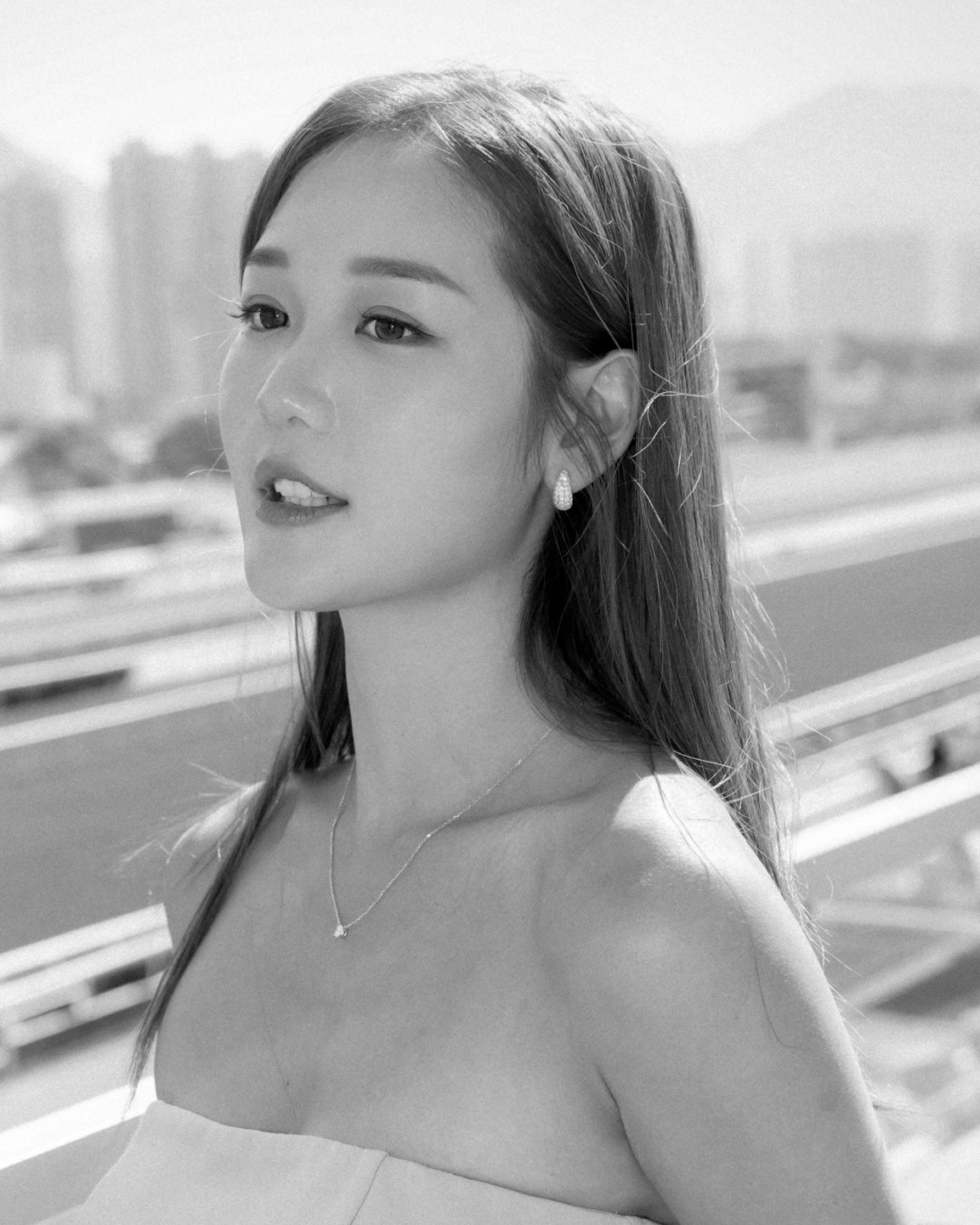 Michelle Ip in diamond teardrop earrings and diamond solitaire necklace 18K white gold
