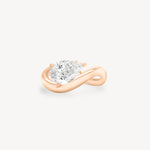 a pear diamond wave band engagement ring in 18K rose gold set against a white background