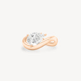 a pear diamond wave band engagement ring in 18K rose gold set against a white background
