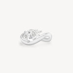 a pear diamond wave band engagement ring in 18K white gold set against a white background
