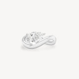 a pear diamond wave band engagement ring in 18K white gold set against a white background