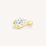 a pear diamond wave band engagement ring in 18K yellow gold set against a white background