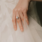 bride wearing a pear cut diamond ring in knifes edge setting 