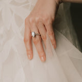 bride wearing a pear cut diamond ring in knifes edge setting 