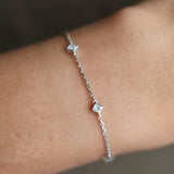Princess cut diamond station bracelet in white gold worn on wrist – tinxx jewelry