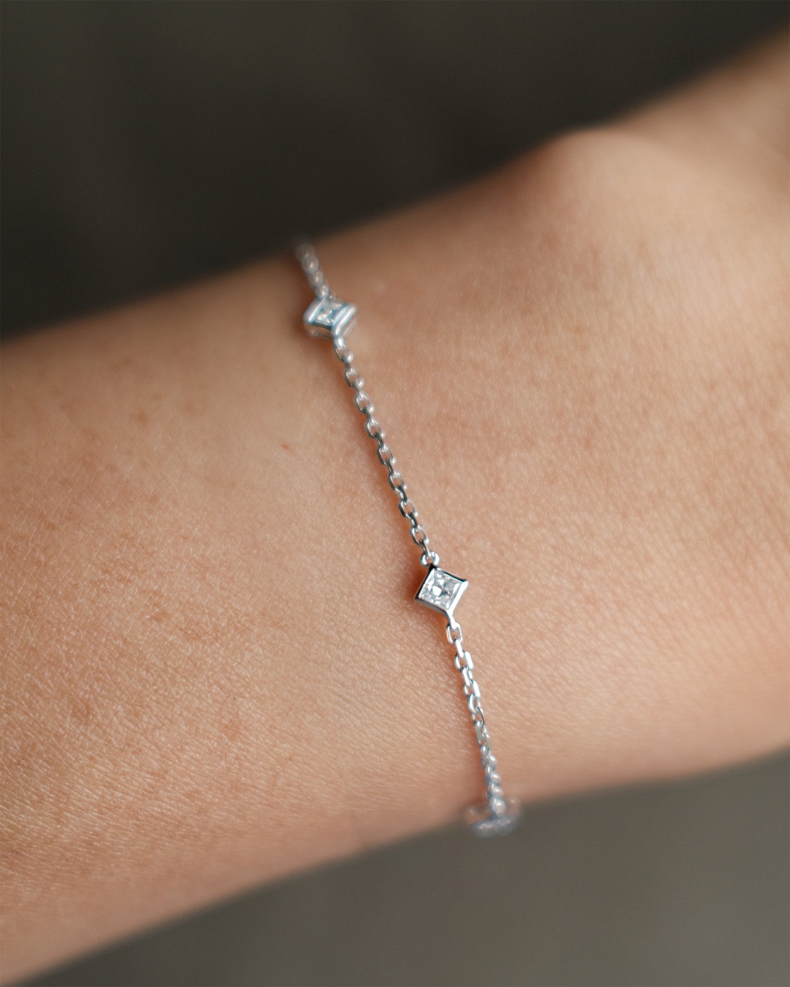 Princess cut diamond station bracelet in white gold worn on wrist – tinxx jewelry