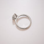Round cut diamond pavé ring with hidden halo in white gold, side profile on a soft neutral background – tinxx jewelry