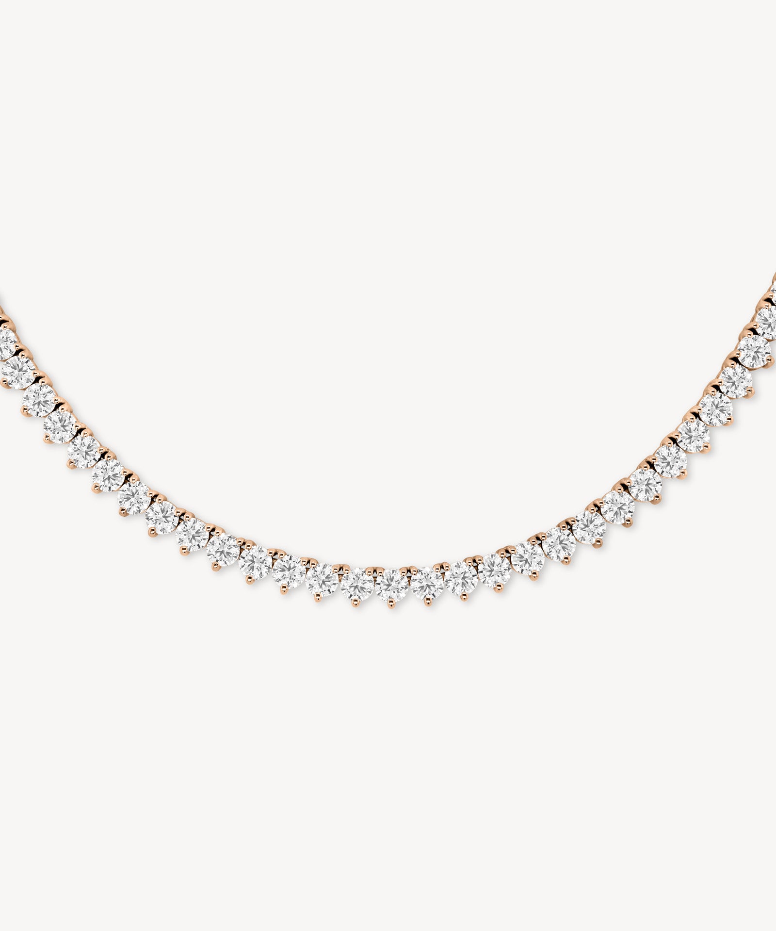 Round cut diamond tennis necklace in scalloped three-prong setting in rose gold