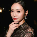 Cindy Wong wearing the tinxx jewelry XOXO ring with a blurred background