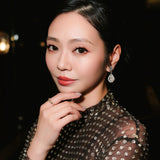 Cindy Wong wearing the tinxx jewelry XOXO ring with a blurred background