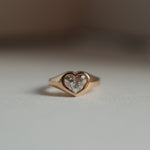 Front view of a 18K yellow gold heart shaped diamond signet ring