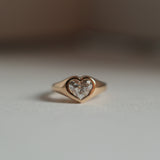 Front view of a 18K yellow gold heart shaped diamond signet ring